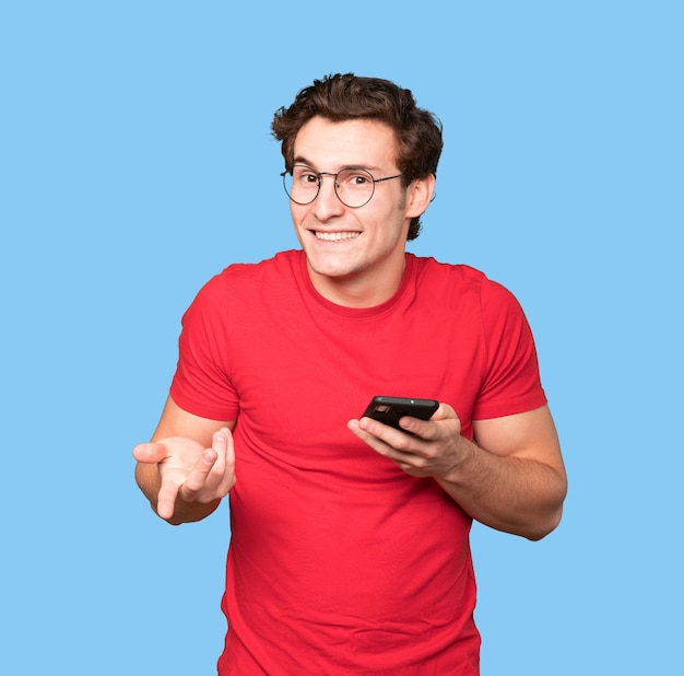 Happy young man using his mobile phone