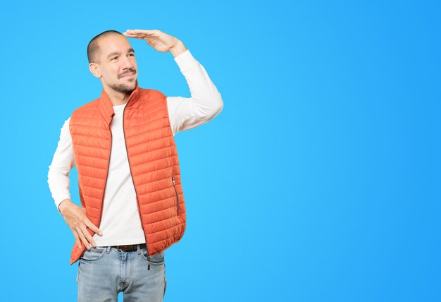 Happy young man with a gesture of looking away