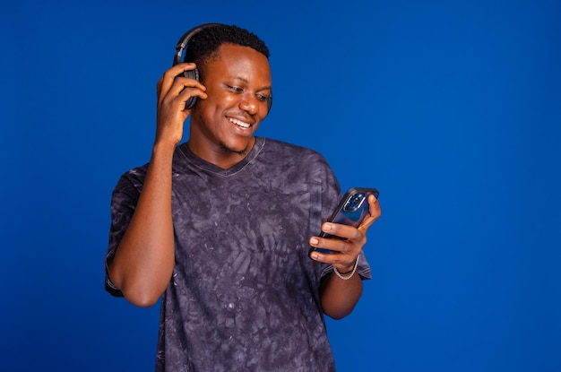 Happy young man with headphones Listening music