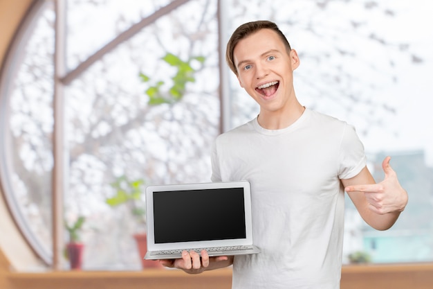 Happy young man with laptop