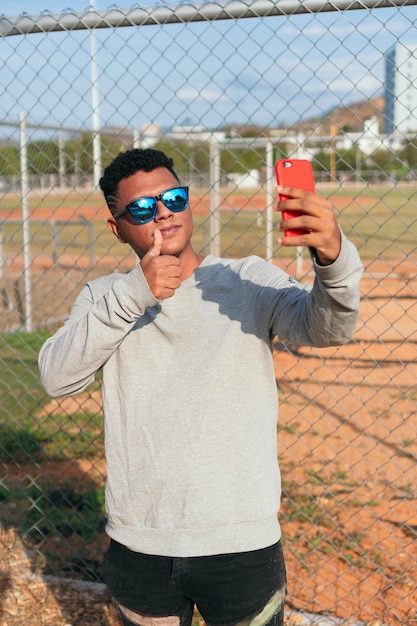 Happy young man with mobile phone in the city