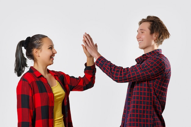 Happy young man and woman high fiving