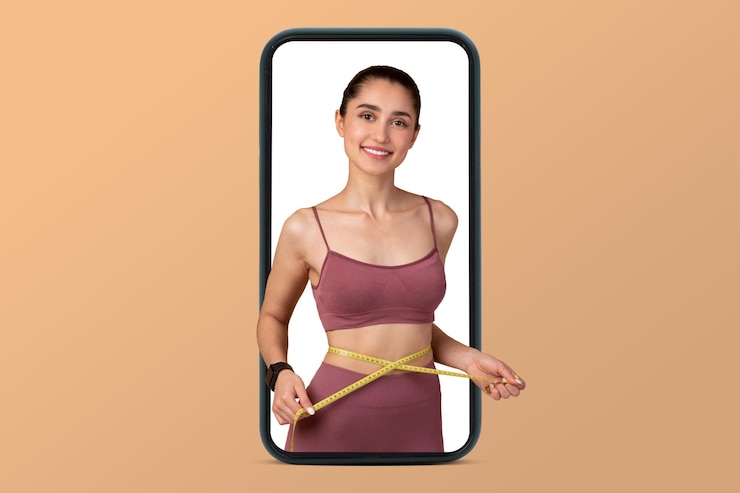 Photo happy young middle eastern slim woman in sportswear measures waist with measuring tape on smartphone