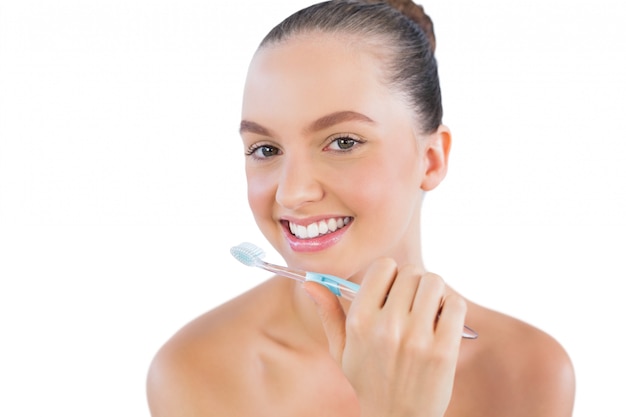 Happy young model with toothbrush