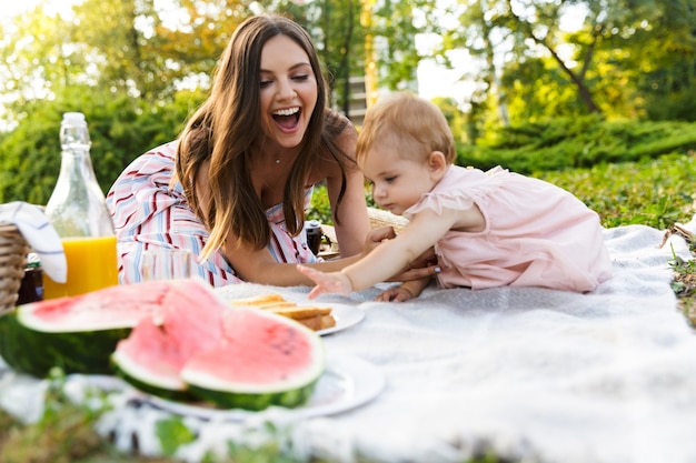 Felice giovane madre con la sua piccola figlia al parco