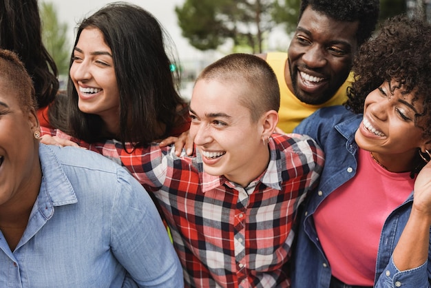 Happy young multiracial people having fun together at city park Diversity and friendship concept