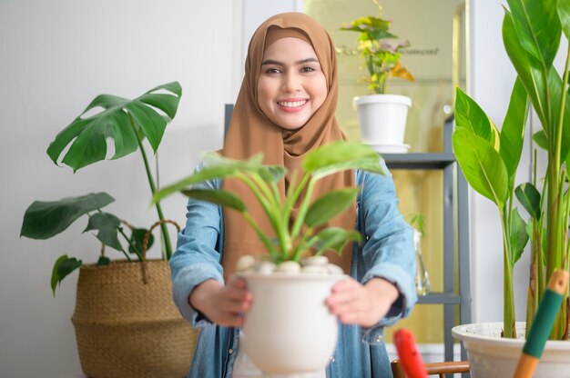 A happy young muslim woman enjoying  and relaxing leisure activity in garden at home