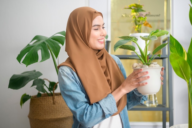 A happy young muslim woman enjoying  and relaxing leisure activity in garden at home