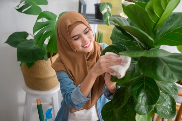 A happy young muslim woman enjoying and relaxing leisure activity in garden at home