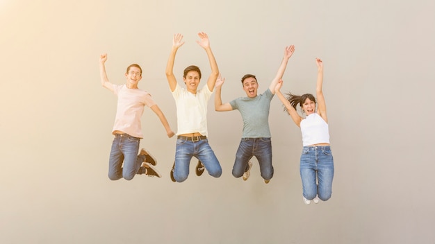 Happy young people jumping together