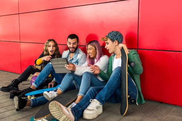 Happy young people meeting outdoors. group of cheerful teenagers having fun