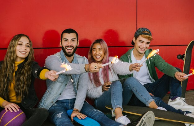 Happy young people meeting outdoors. group of cheerful teenagers having fun