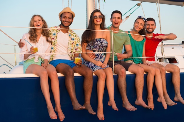 Happy young people sailing on the yacht