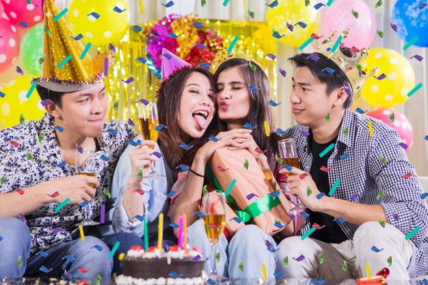 Happy young people take photo at birthday party