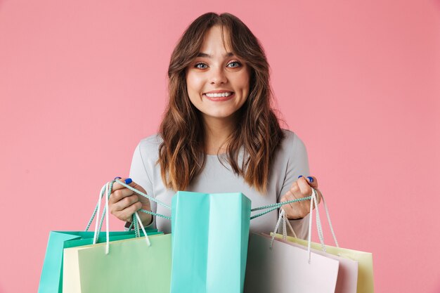 Happy young pretty woman shopaholic holding shopping bags.