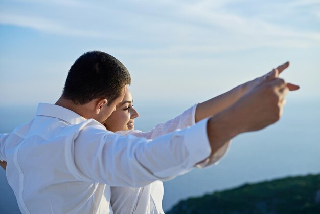 happy young romantic couple have fun relax smile at modern home outdoor terace balcony