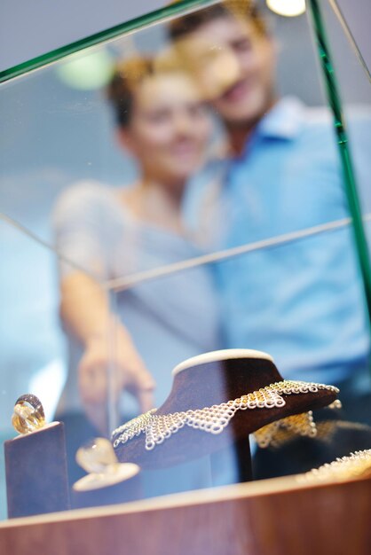 Happy young romantic couple in love buy jewelry ring in luxury store