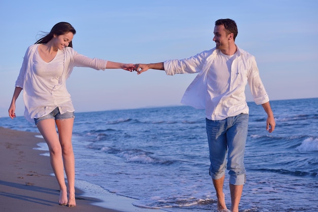 happy young romantic couple in love have fun on beautiful beach at beautiful summer day