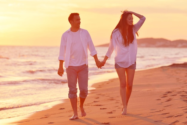 happy young romantic couple in love have fun on beautiful beach at beautiful summer day