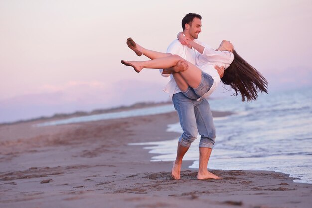 happy young romantic couple in love have fun on beautiful beach at beautiful summer day