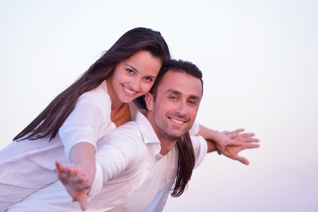 happy young romantic couple in love have fun on beautiful beach at beautiful summer day