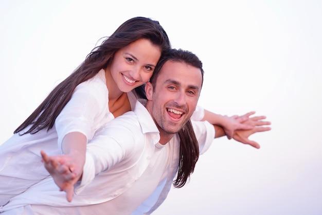 happy young romantic couple in love have fun on beautiful beach at beautiful summer day