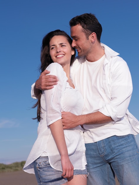 happy young romantic couple in love have fun on beautiful beach at beautiful summer day