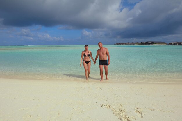 happy young romantic couple in love have fun running and relaxing on beautiful beach