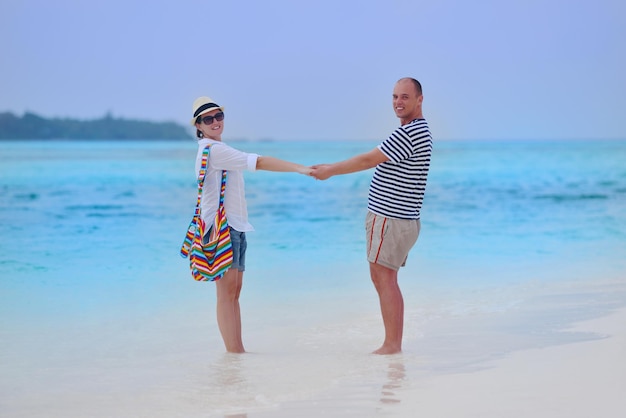 happy young romantic couple in love have fun running and relaxing on beautiful beach