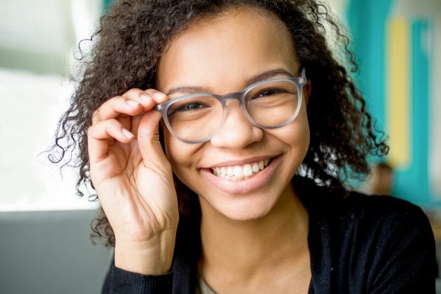 Happy young student or businesswoman in eyeglasses