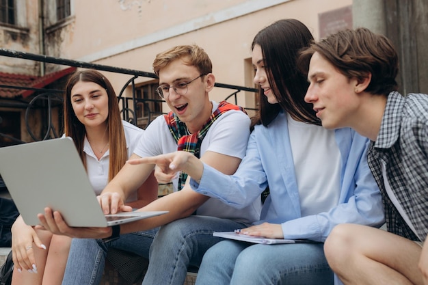 Happy young students are chatting in campus