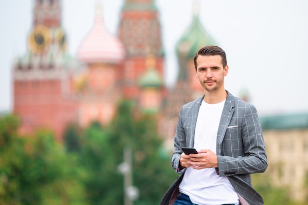 Happy young urban man in european city.