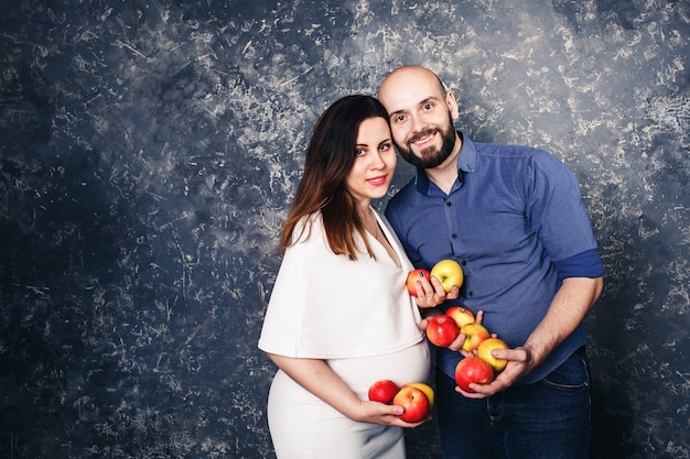 Happy young vegan family pregnant girl and bearded man