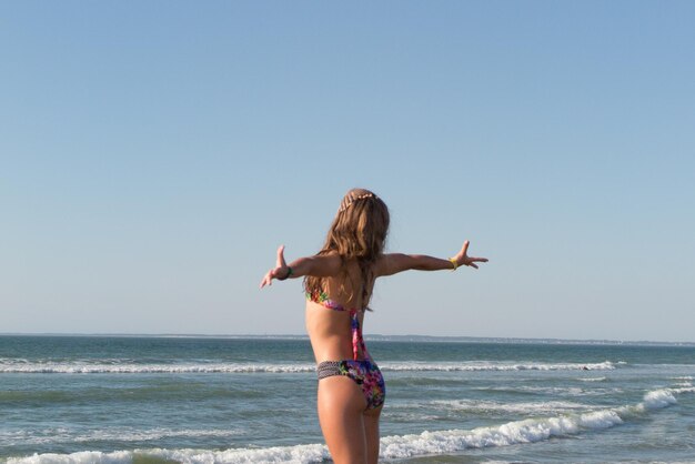 Happy young woman on the beach all tanned