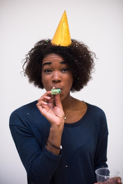 happy young woman celebrating new years eve party while blowing confetti