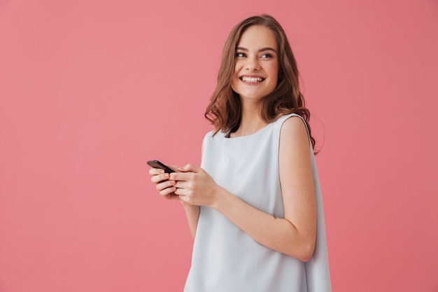 Happy young woman chatting by phone.