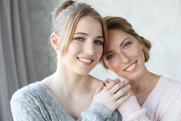 Happy young woman and her mother at home happy family