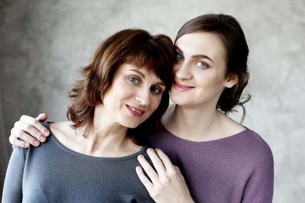 Happy young woman and her mother at home happy family