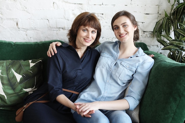 Happy young woman and her mother at home happy family