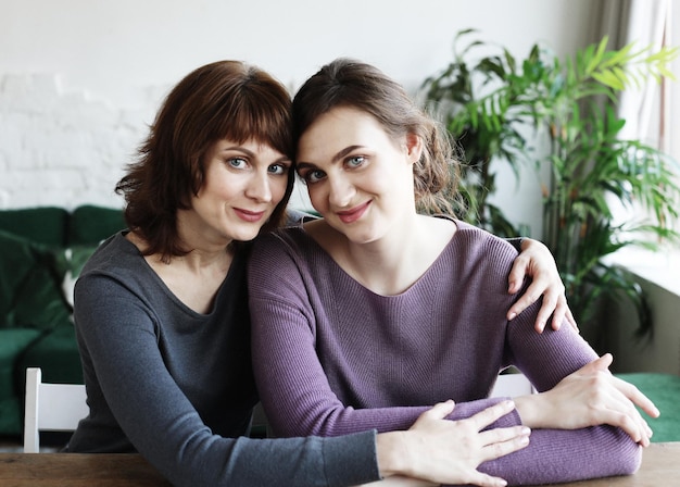 Happy young woman and her mother at home