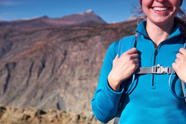 Happy young woman hiking with backpack