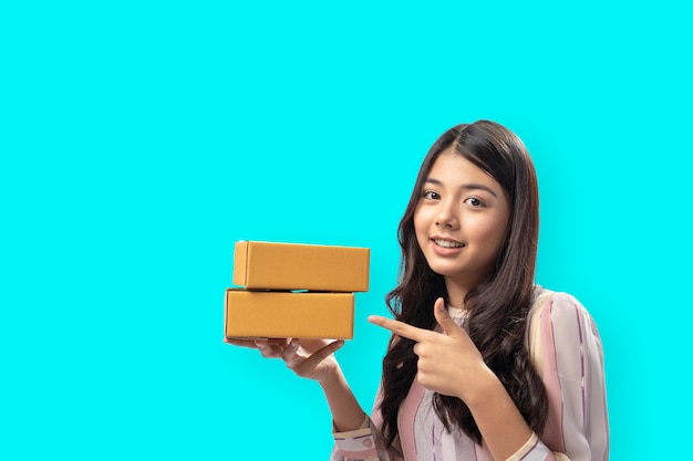 Happy Young Woman hold a Carton Box and colour