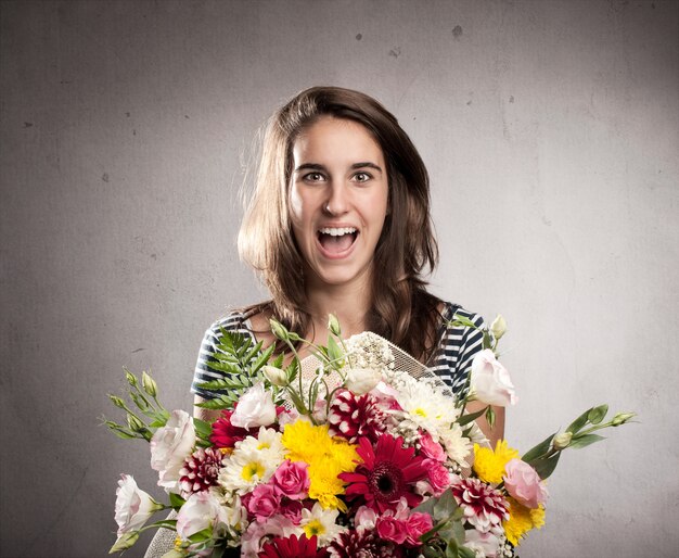 happy young woman holding a bouquet of flowers