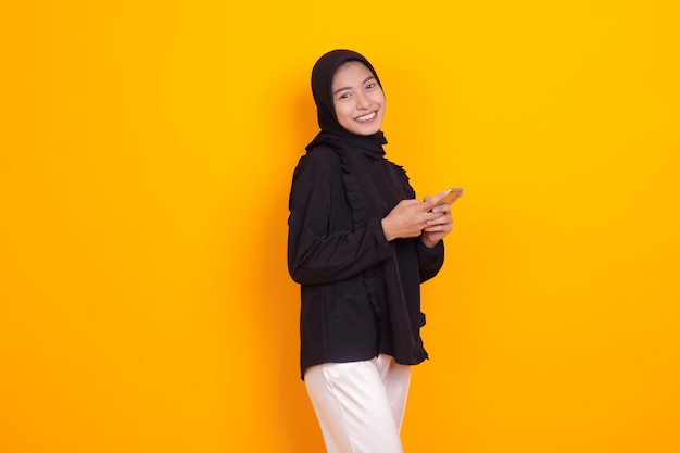 happy young woman holding a cellphone