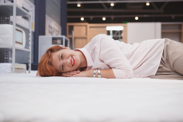 Happy young woman in a home good store