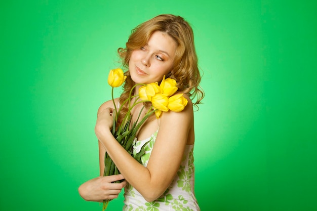 Happy Young Woman hugging a bouquet of tulips