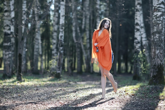 happy young woman jumping in the spring forest