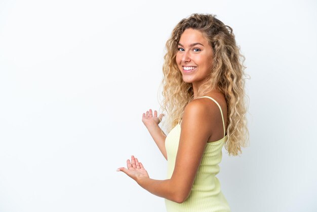 Happy Young woman listening music over isolated yellow wall