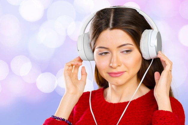 Happy young woman listening music with headphones