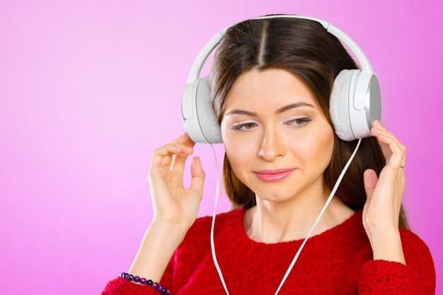 Happy young woman listening music with headphones